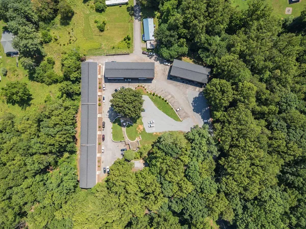 an aerial view of a house with a yard and garden