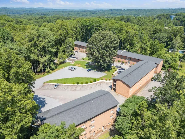 an aerial view of a house with pool yard and outdoor seating