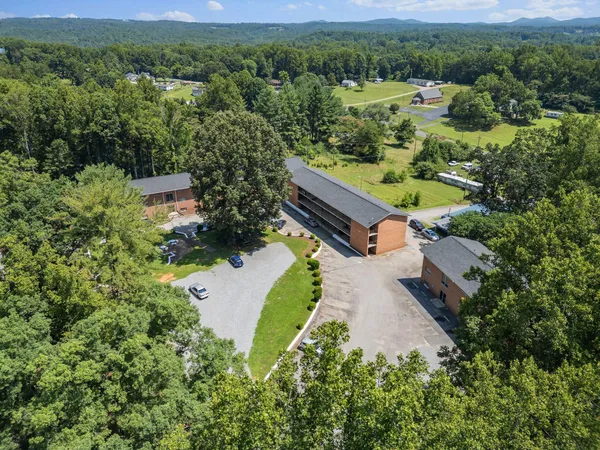 an aerial view of a house with a yard