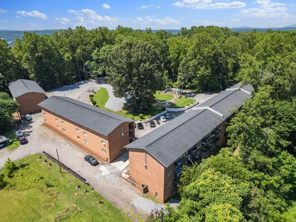 an aerial view of a house with a yard