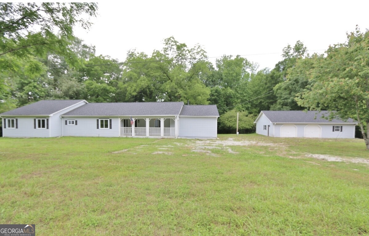 a backyard of a house with table and chairs