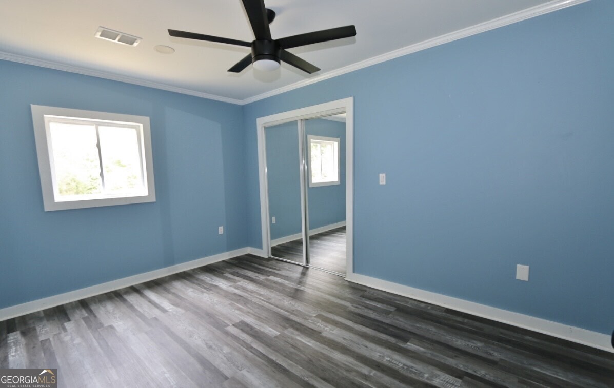3434 Union Point Road Union Point, GA 30669 - Photo 11 of 23 wooden floor in an empty room with a window
