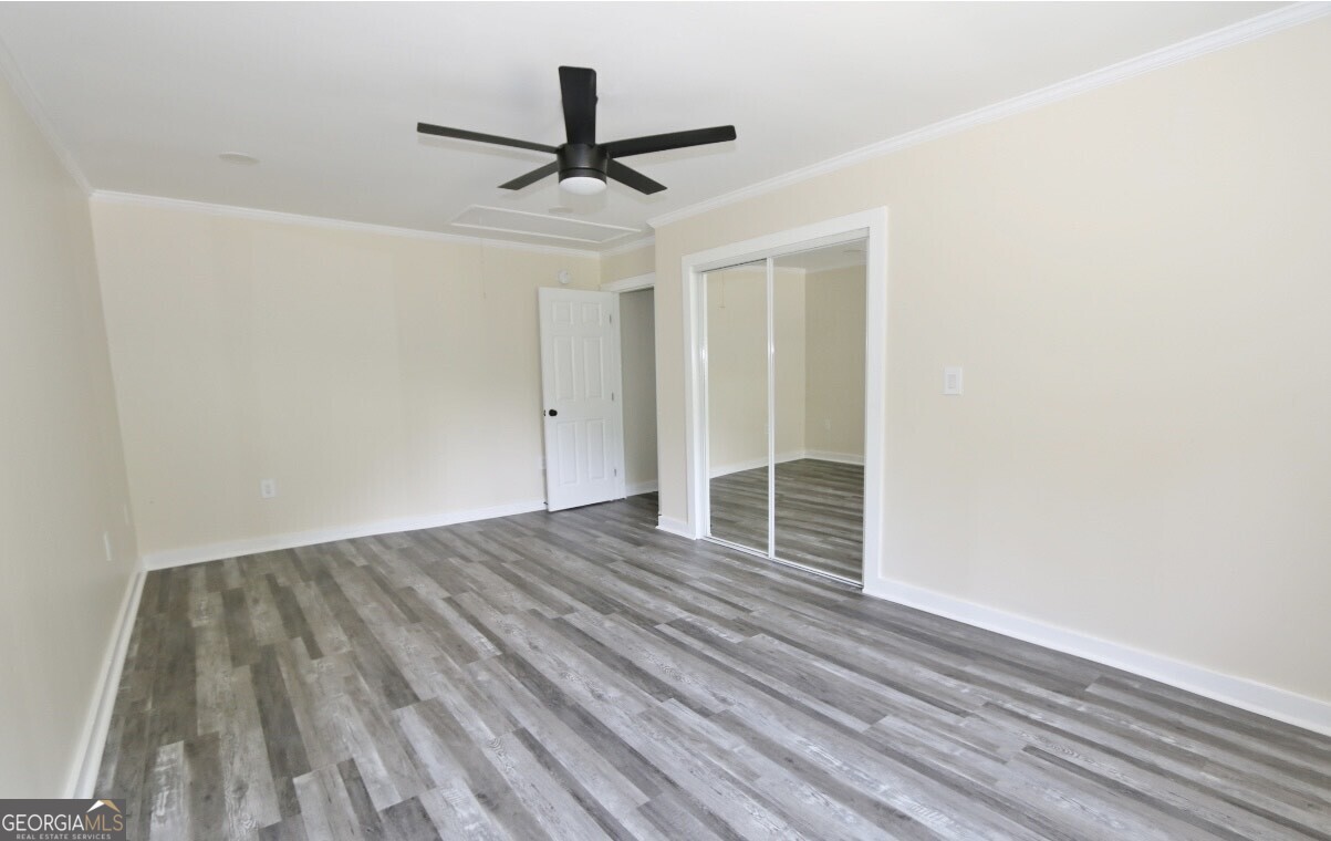 3434 Union Point Road Union Point, GA 30669 - Photo 12 of 23 a view of a livingroom with wooden floor and a ceiling fan