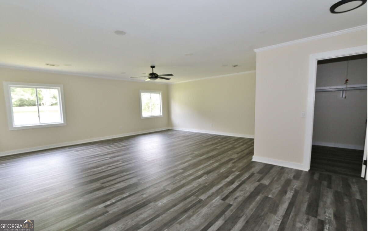 3434 Union Point Road Union Point, GA 30669 - Photo 13 of 23 an empty room with wooden floor and windows
