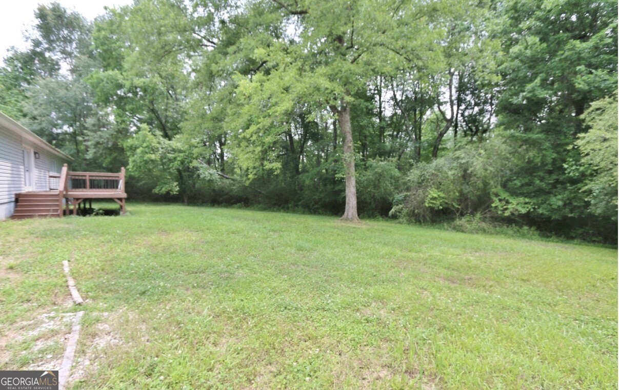 3434 Union Point Road Union Point, GA 30669 - Photo 19 of 23 a view of a backyard with a small cabin