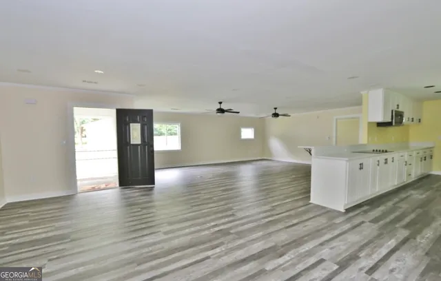 a view of a kitchen with wooden floor and a sink