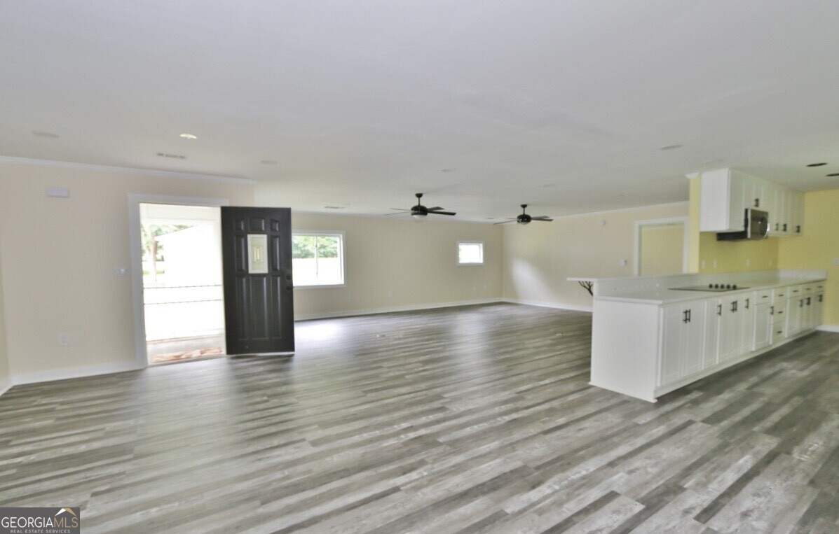 3434 Union Point Road Union Point, GA 30669 - Photo 2 of 23 a view of a kitchen with wooden floor and a sink