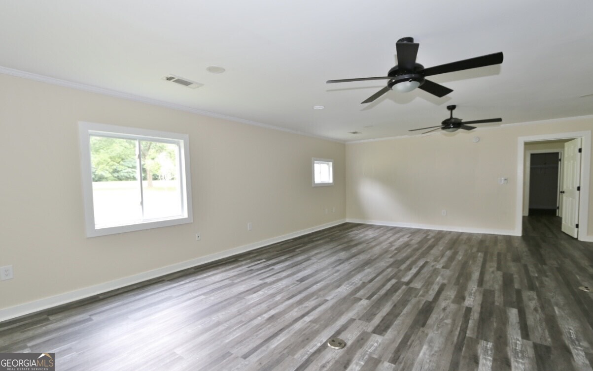 3434 Union Point Road Union Point, GA 30669 - Photo 3 of 23 a view of empty room with wooden floor and fan
