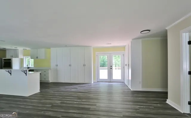a view of a kitchen with wooden floor and a flat screen tv