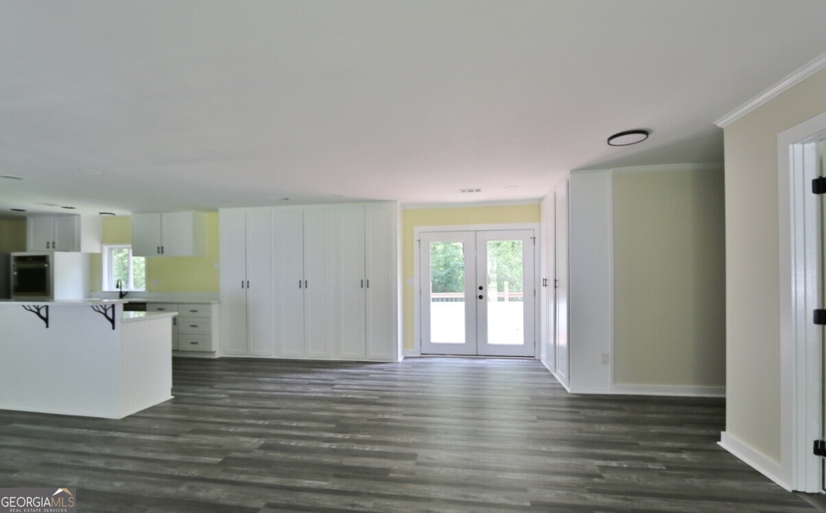 3434 Union Point Road Union Point, GA 30669 - Photo 5 of 23 a view of a kitchen with wooden floor and a flat screen tv