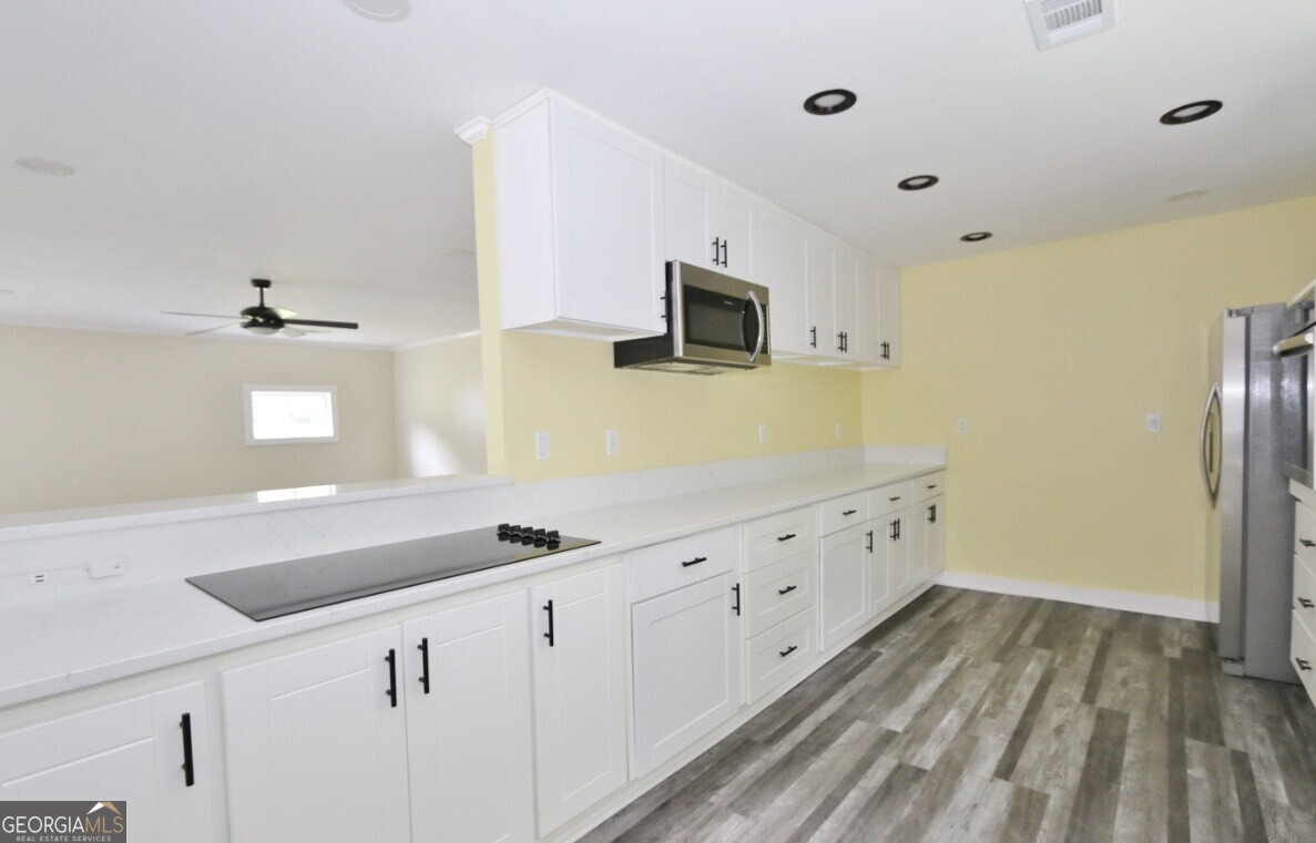 3434 Union Point Road Union Point, GA 30669 - Photo 6 of 23 a kitchen with granite countertop a sink and a stove top oven