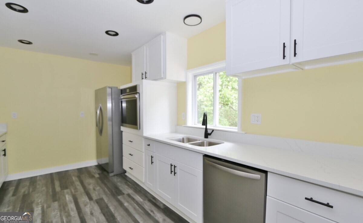 3434 Union Point Road Union Point, GA 30669 - Photo 7 of 23 a kitchen with a sink and a refrigerator