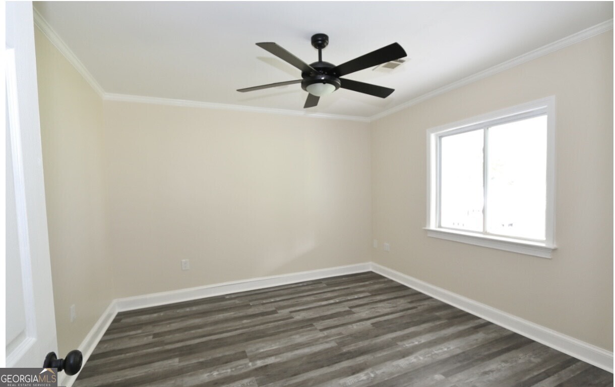 3434 Union Point Road Union Point, GA 30669 - Photo 8 of 23 an empty room with wooden floor and windows