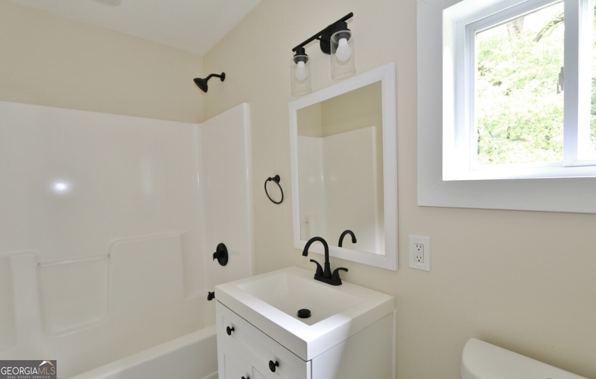 3434 Union Point Road Union Point, GA 30669 - Photo 9 of 23 a bathroom with a sink a toilet and shower