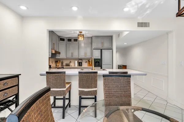 a kitchen with a table chairs stove and cabinets