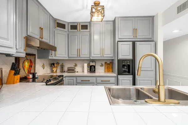 a kitchen with stainless steel appliances granite countertop a sink and cabinets