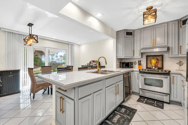 a kitchen with appliances cabinets and furniture
