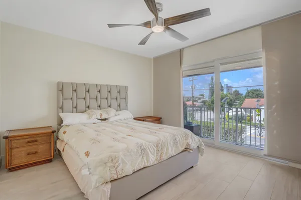 a large bed sitting in a bedroom next to a window