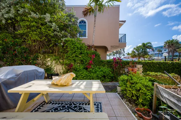 a view of backyard with outdoor seating and green space