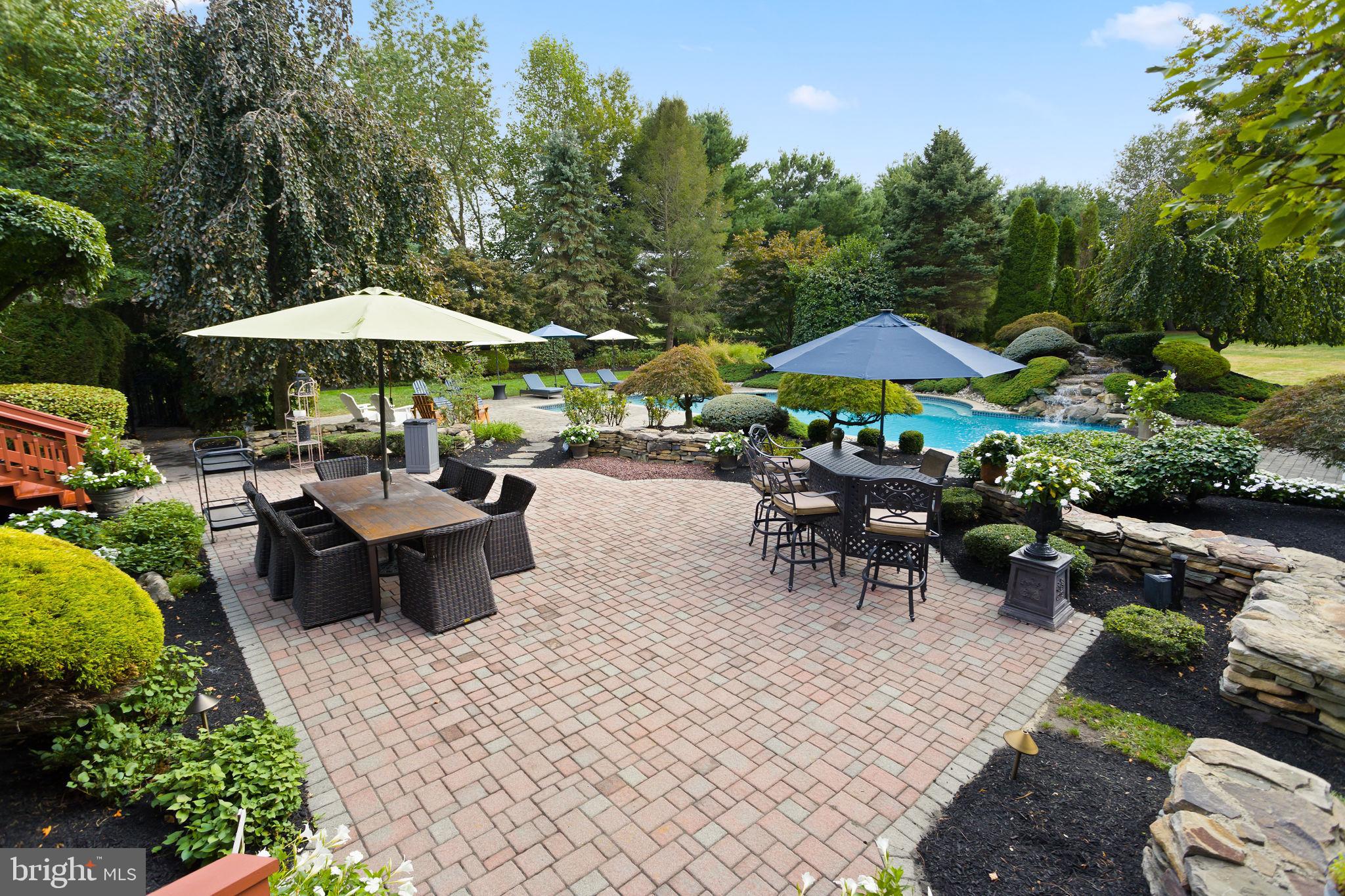 44 Walters Road Robbinsville, NJ 08691 - Photo 51 of 68 a couple of tables and chairs under an umbrella in backyard