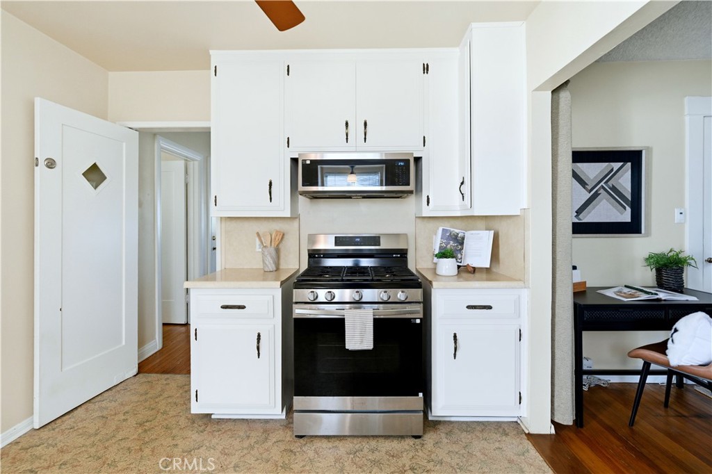 347 Euclid Avenue Long Beach, CA 90814 - Photo 8 of 41 a kitchen with stainless steel appliances a stove a microwave and cabinets
