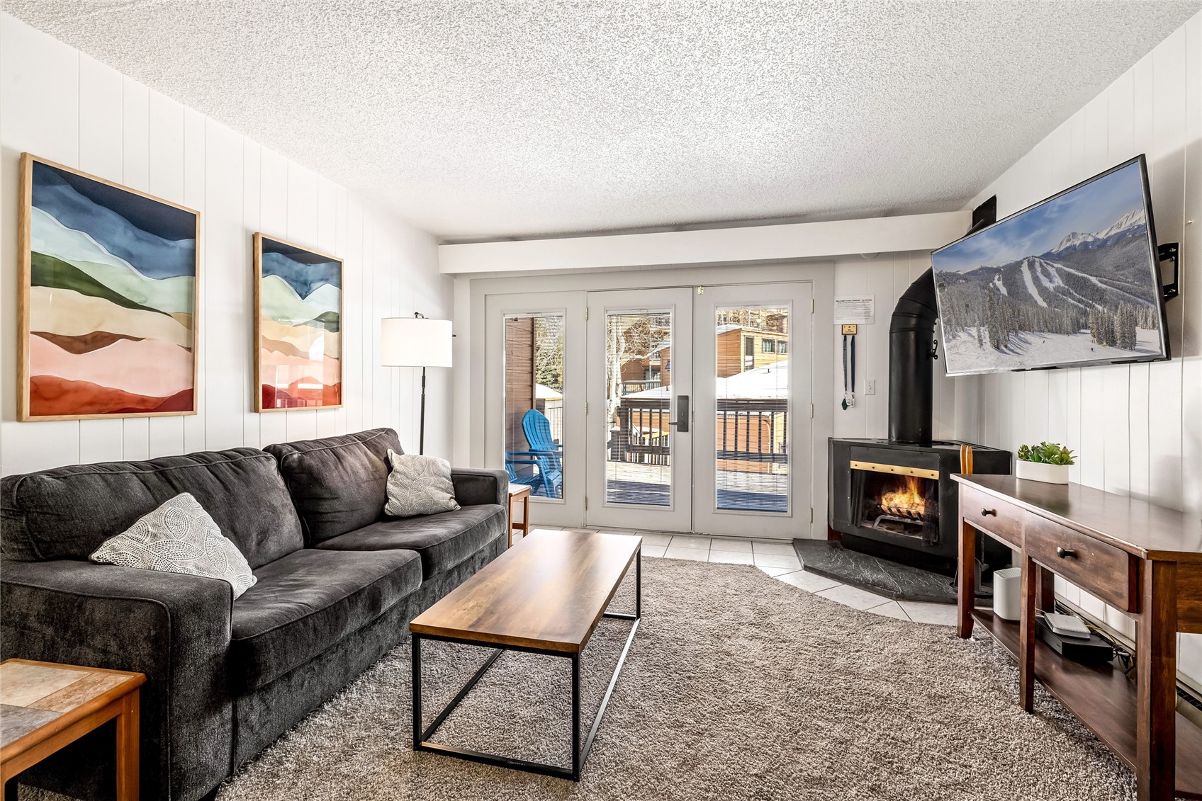 1473 East Keystone Road, Unit 2928 Keystone, CO 80435 - Photo 16 of 30 Tiled living room with french doors, a textured ceiling, and a wood stove