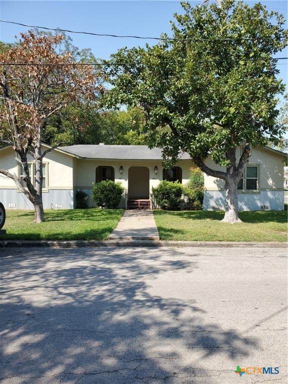 826 North Bowie Street Seguin, TX 78155 - Photo 1 of 9 a view of white house with a big yard and large trees