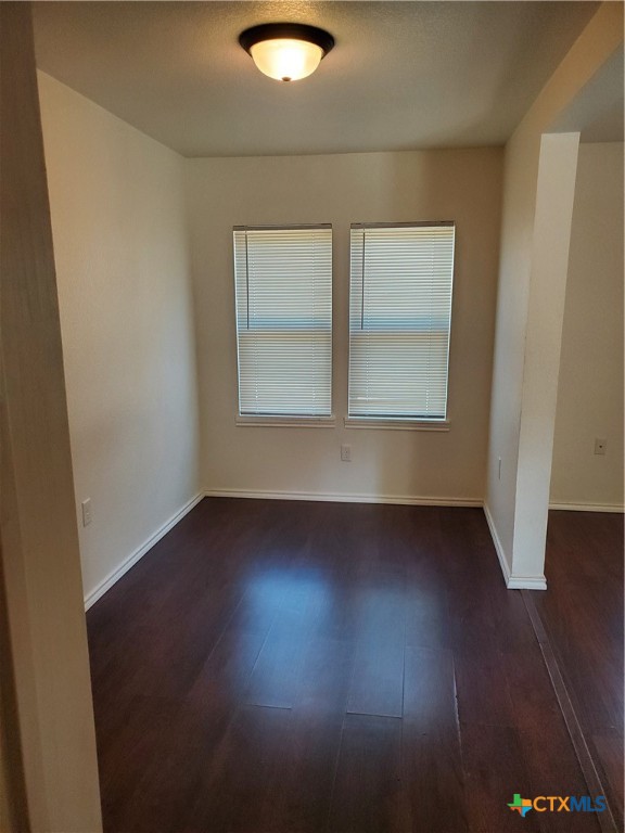 826 North Bowie Street Seguin, TX 78155 - Photo 5 of 9 an empty room with wooden floor and windows