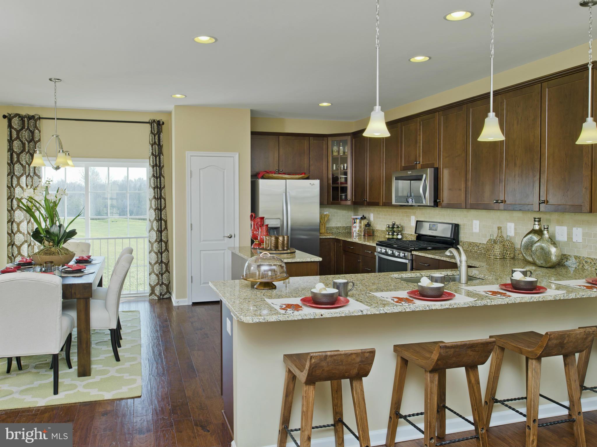 908 Sandy Run Road Middle River, MD 21220 - Photo 3 of 24 a kitchen with a dining table chairs and refrigerator