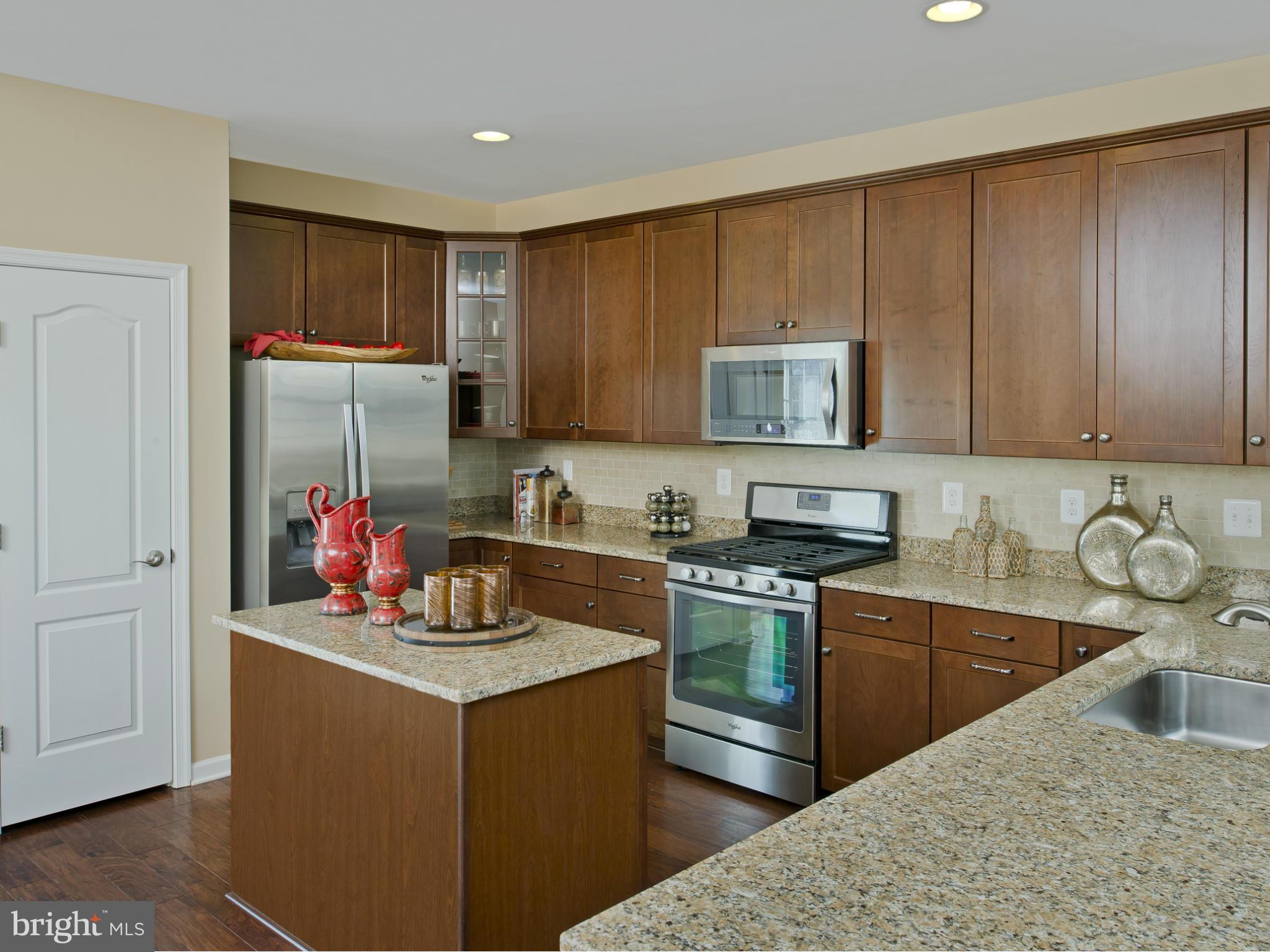 908 Sandy Run Road Middle River, MD 21220 - Photo 4 of 24 a kitchen with stainless steel appliances granite countertop a sink stove and refrigerator