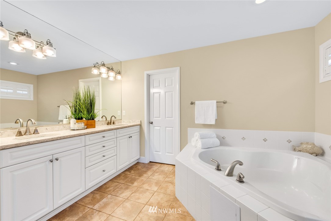 3613 209th Place Southeast Bothell, WA 98021 - Photo 17 of 28 a bathroom with a tub a sink and mirror