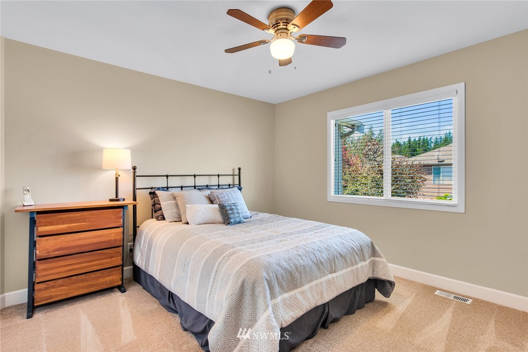 3613 209th Place Southeast Bothell, WA 98021 - Photo 19 of 28 a bedroom with a bed and a chandelier