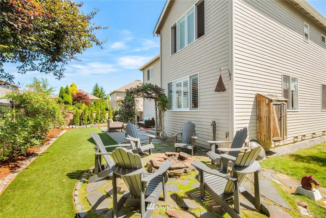 3613 209th Place Southeast Bothell, WA 98021 - Photo 26 of 28 a view of a patio with table and chairs and potted plants