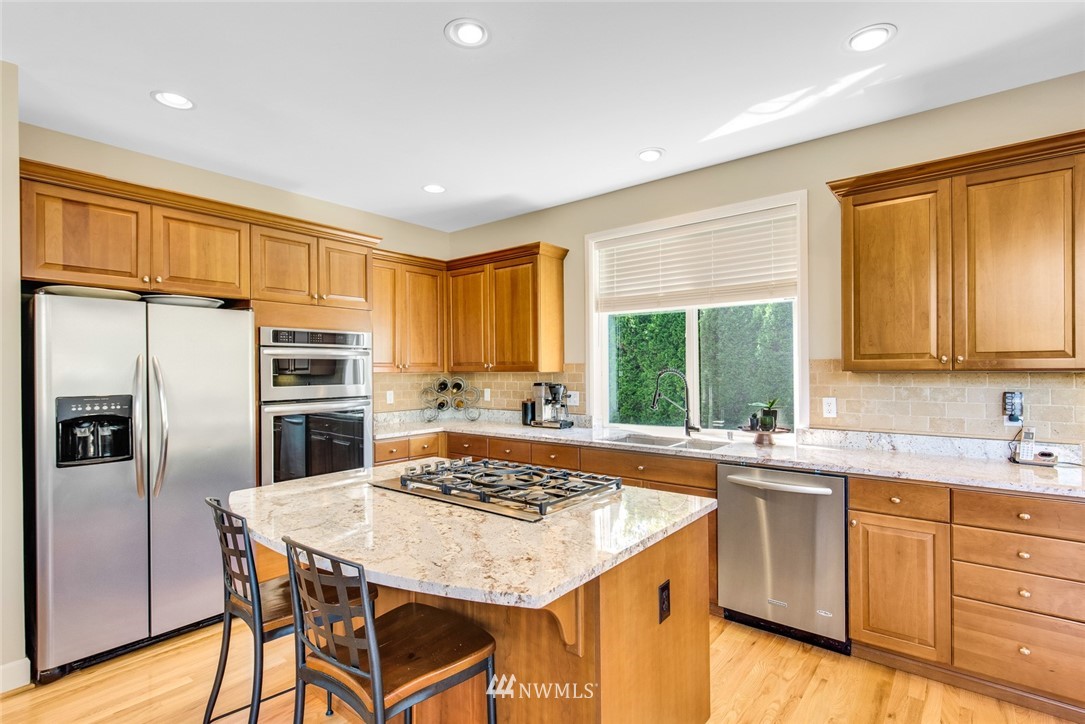 3613 209th Place Southeast Bothell, WA 98021 - Photo 9 of 28 a kitchen with a stove a sink and a refrigerator