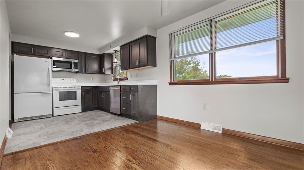 119 Linden Road Canonsburg, PA 15317 - Photo 14 of 41 a kitchen with stainless steel appliances granite countertop a refrigerator a sink dishwasher a stove with wooden cabinets and floors