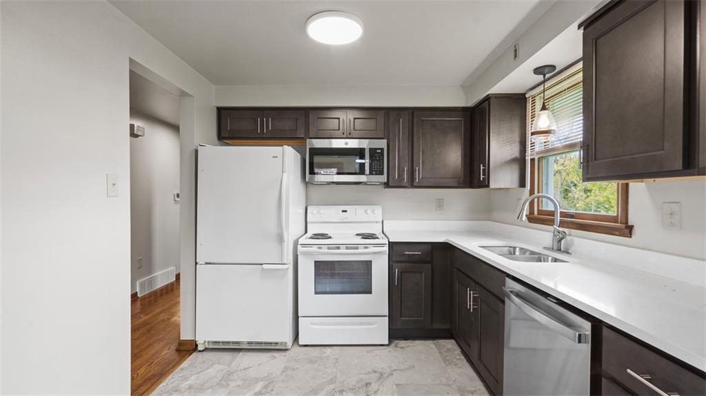 119 Linden Road Canonsburg, PA 15317 - Photo 15 of 41 a kitchen with a sink a microwave a refrigerator and cabinets