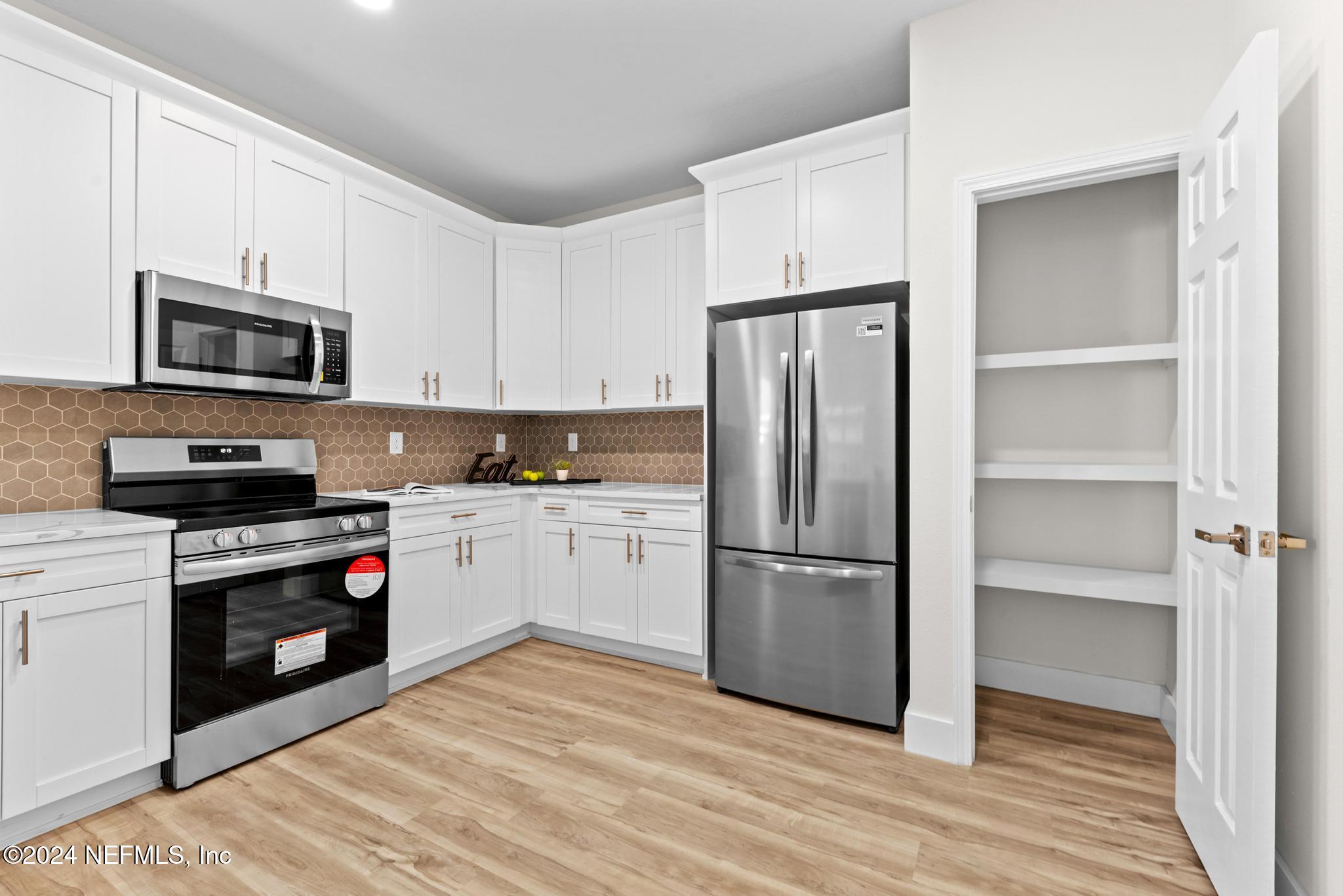 12731 Old St Augustine Road Jacksonville, FL 32258 - Photo 11 of 24 a kitchen with a refrigerator stove and microwave