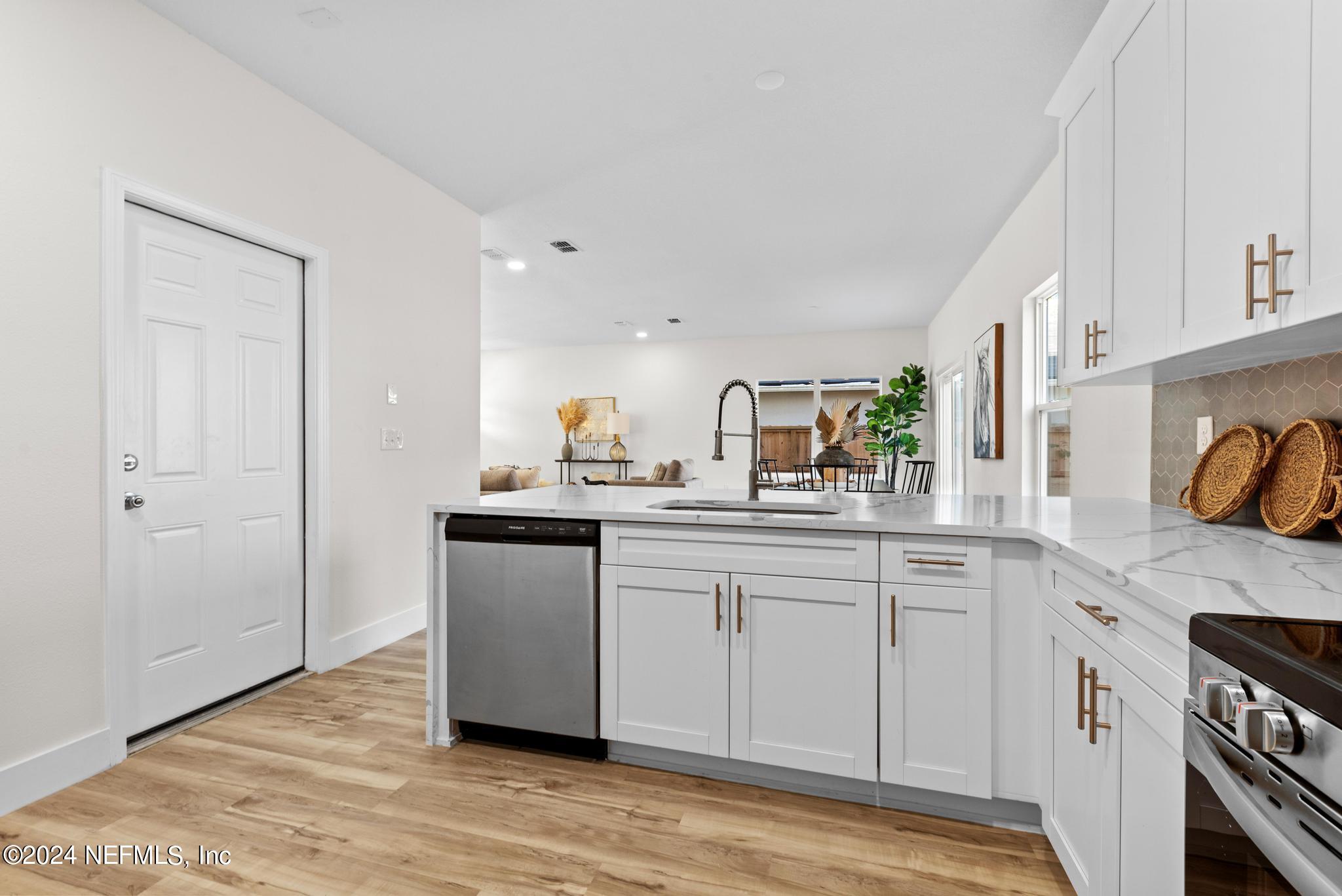 12731 Old St Augustine Road Jacksonville, FL 32258 - Photo 12 of 24 a kitchen with stainless steel appliances granite countertop a sink and cabinets