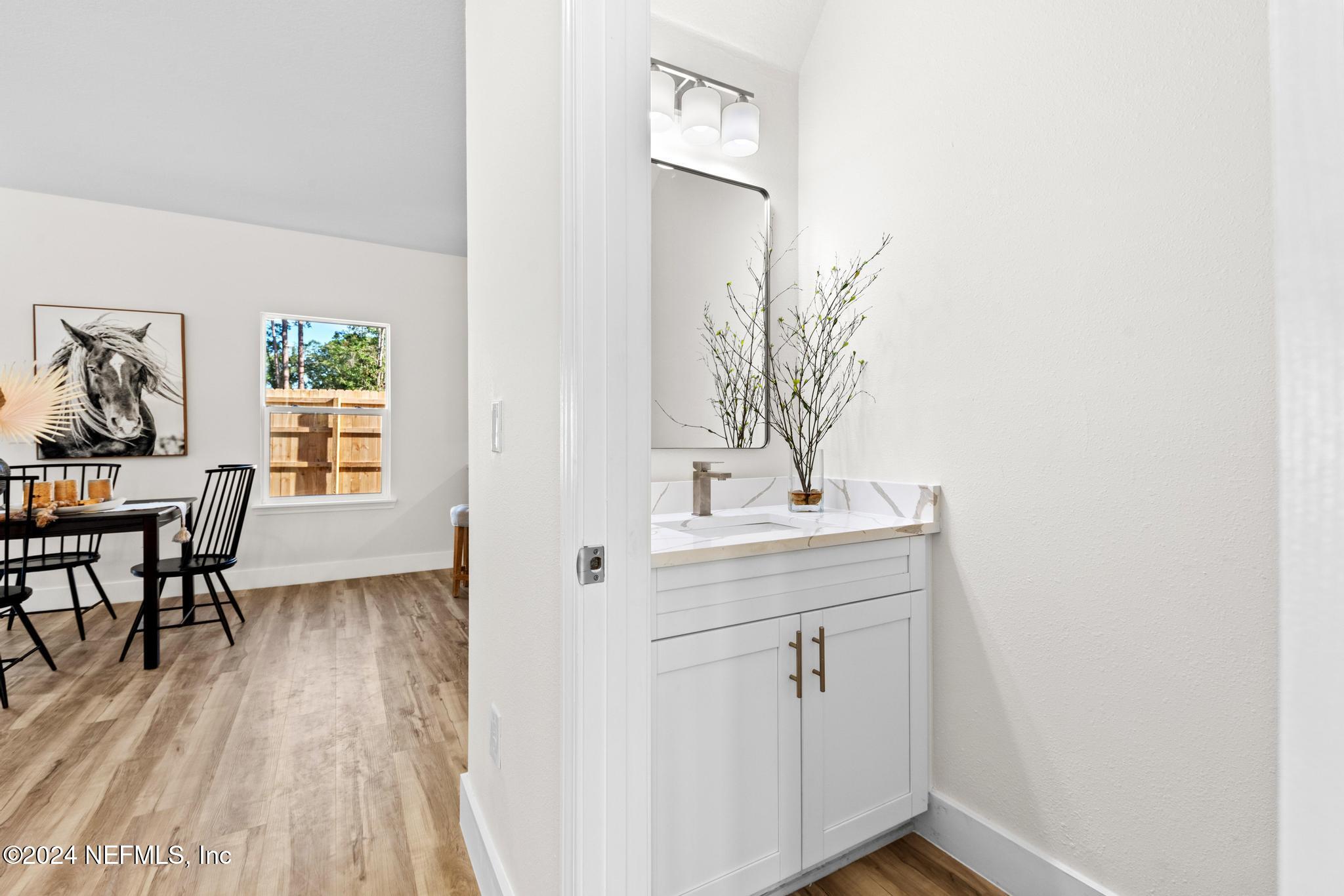 12731 Old St Augustine Road Jacksonville, FL 32258 - Photo 13 of 24 a view of hallway with furniture and wooden floor