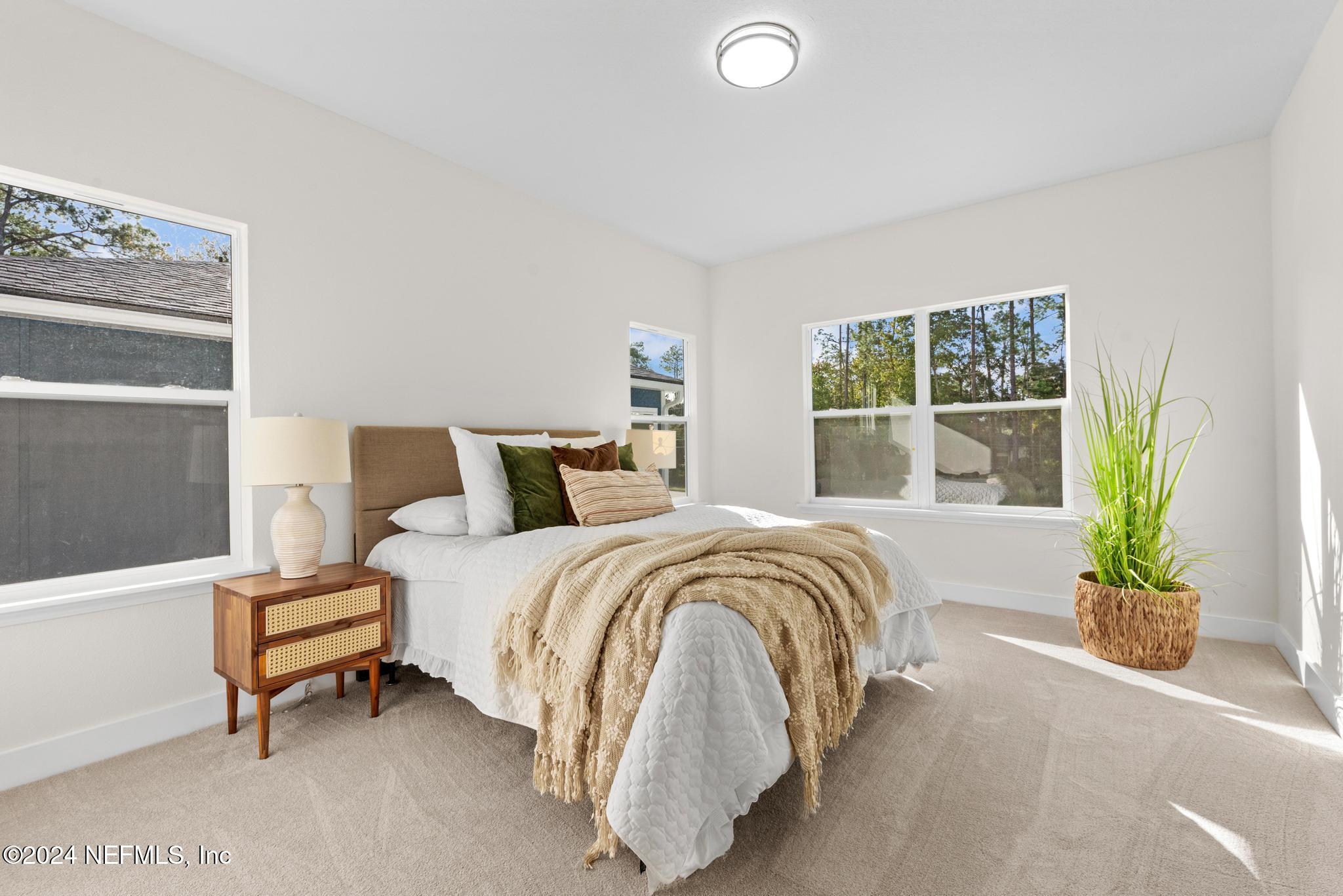 12731 Old St Augustine Road Jacksonville, FL 32258 - Photo 14 of 24 a spacious bedroom with a bed and a window