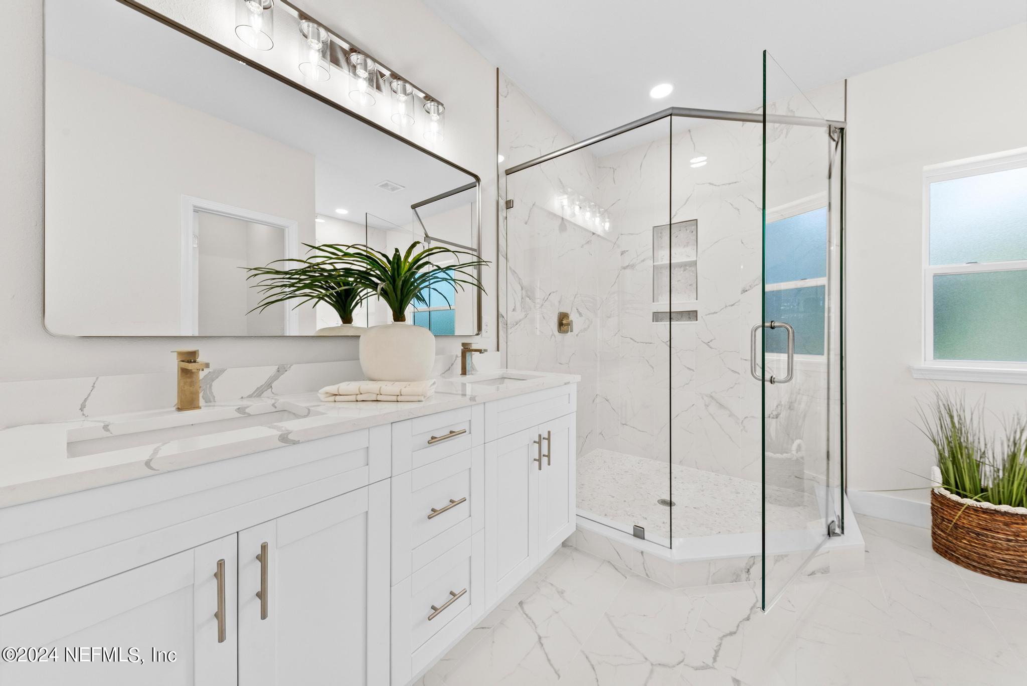 12731 Old St Augustine Road Jacksonville, FL 32258 - Photo 16 of 24 a bathroom with a granite countertop sink a mirror and a shower