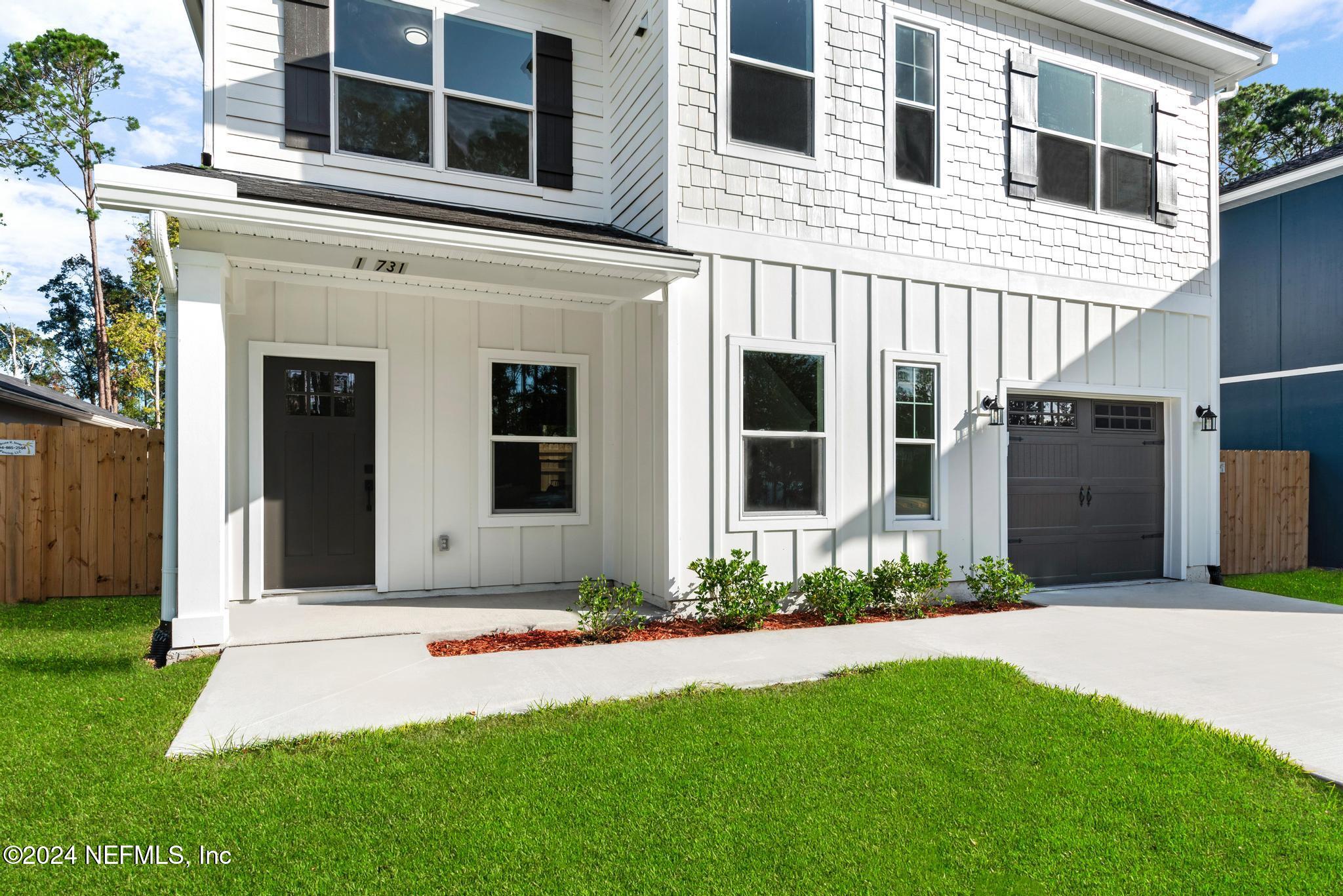12731 Old St Augustine Road Jacksonville, FL 32258 - Photo 2 of 24 a front view of a house with a yard and garage