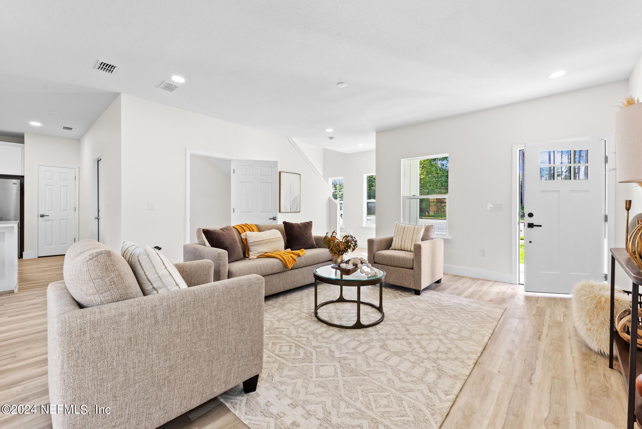 12731 Old St Augustine Road Jacksonville, FL 32258 - Photo 5 of 24 a living room with furniture a large window and a rug