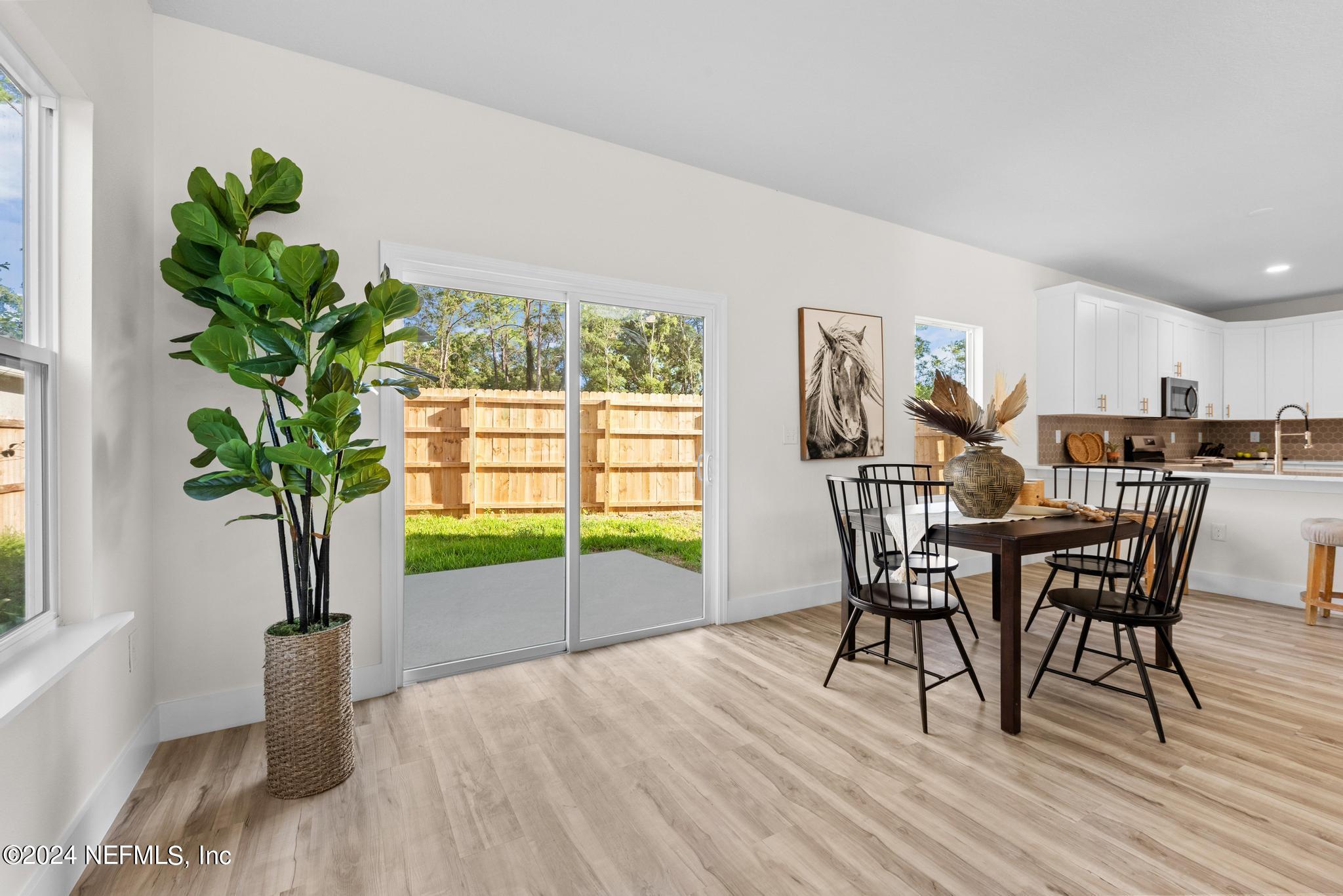 12731 Old St Augustine Road Jacksonville, FL 32258 - Photo 6 of 24 a view of a dining room with furniture and a potted plant