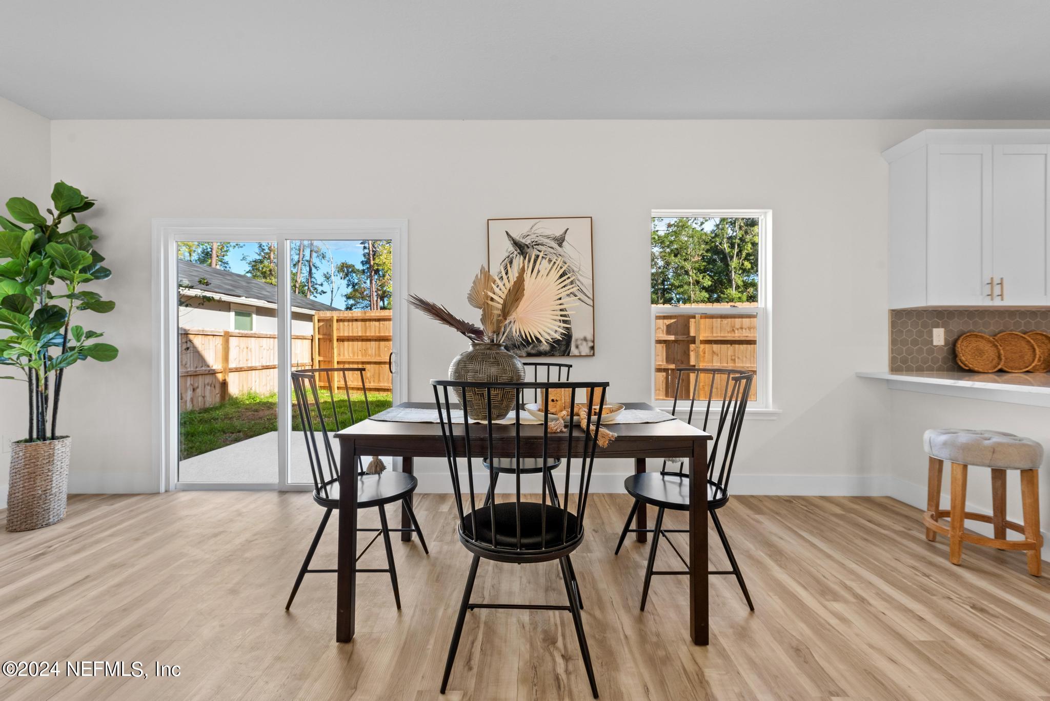 12731 Old St Augustine Road Jacksonville, FL 32258 - Photo 8 of 24 a view of a dining room with furniture and wooden floor