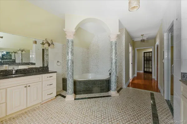a bathroom with a granite countertop sink a toilet and a mirror