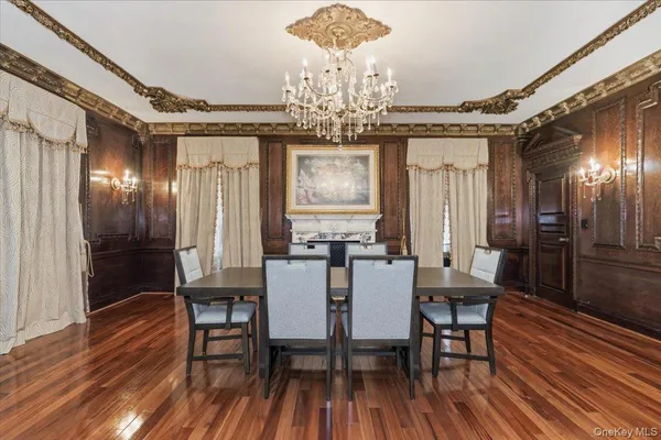 a lobby room with fireplace furniture and a chandelier