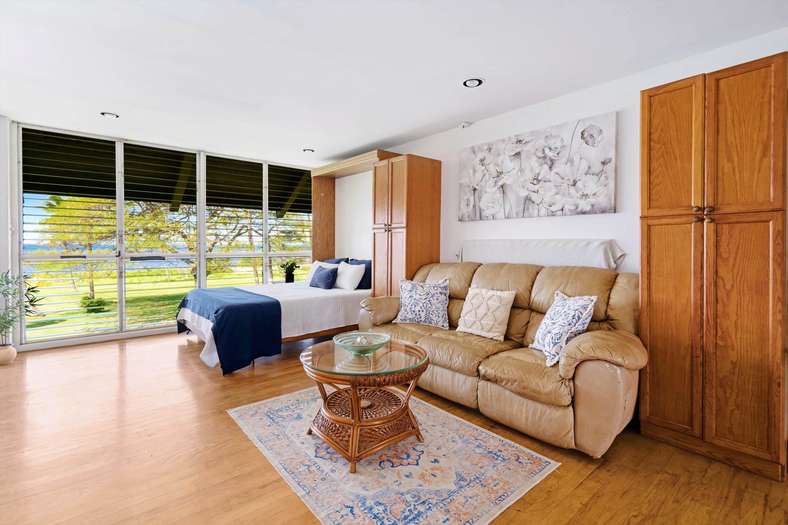 1002 South Kihei Road, Unit 314 Kihei, HI 96753 - Photo 16 of 31 a living room with furniture floor to ceiling window and a flat screen tv