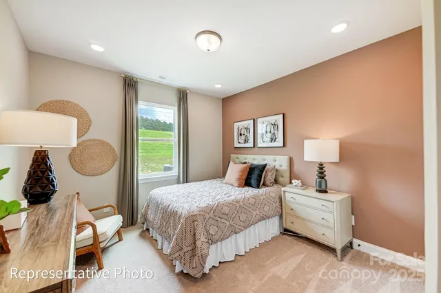 a bedroom with a bed mirror and window