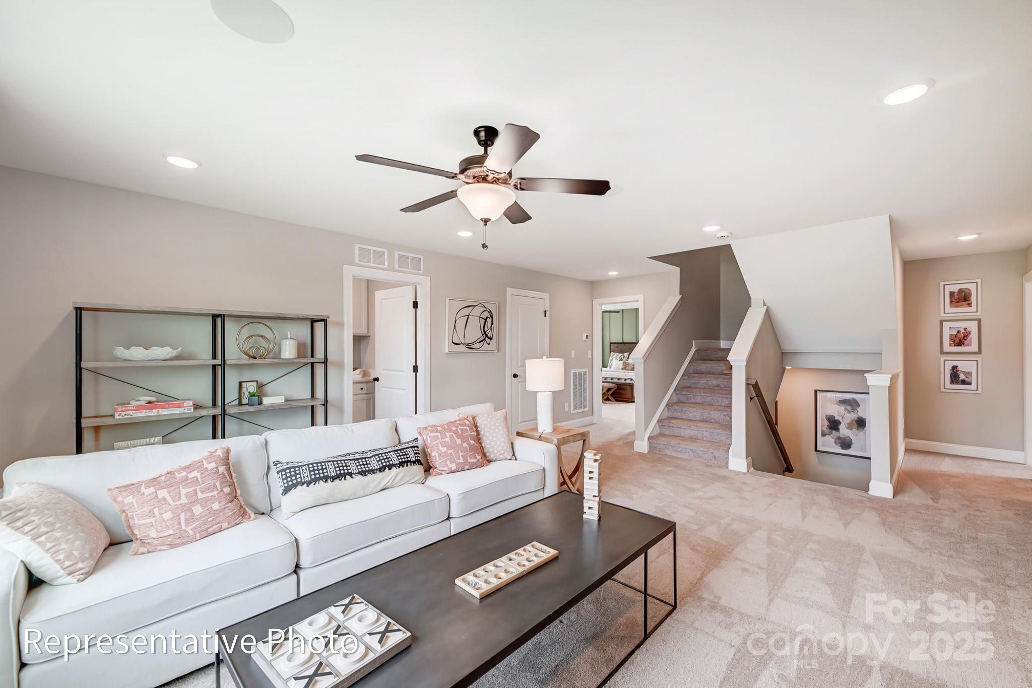 5038 Mclaughlin Loop Waxhaw, NC 28173 - Photo 14 of 25 a living room with furniture and a ceiling fan